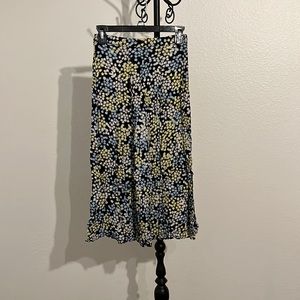 Midi black skirt with blue, white, and yellow flowers. Size 2